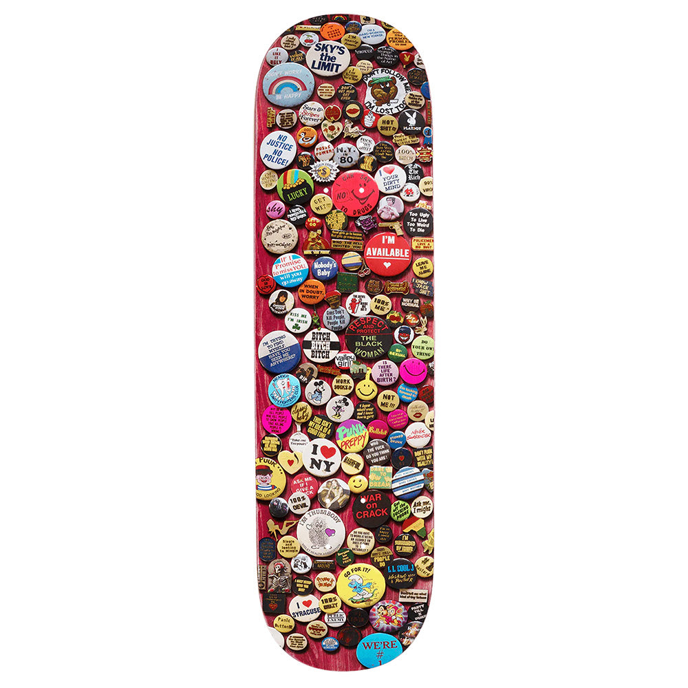 The violet VIOLET PINS PINK skateboard deck features an array of colorful pins and buttons with eclectic slogans, images, and designs inspired by William Strobeck’s creative spirit.