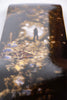 A LIMOSINE skateboard with a reflection of a person.