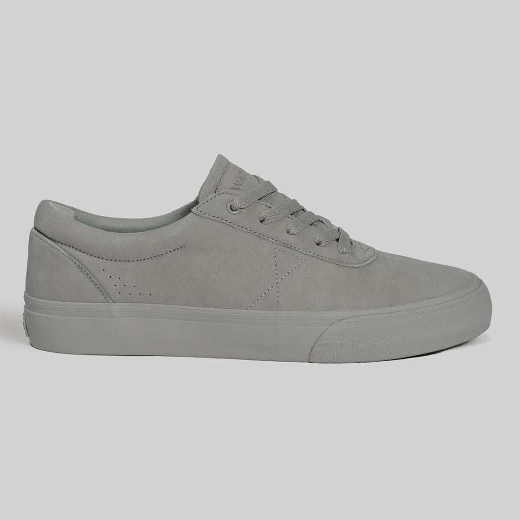 The CHAPTER | STONE FG NUBUCK by WARSAW LTD is a minimal, low-top grey sneaker with laces and a rubber sole, crafted from full-grain nubuck and shown in side profile on a neutral background.