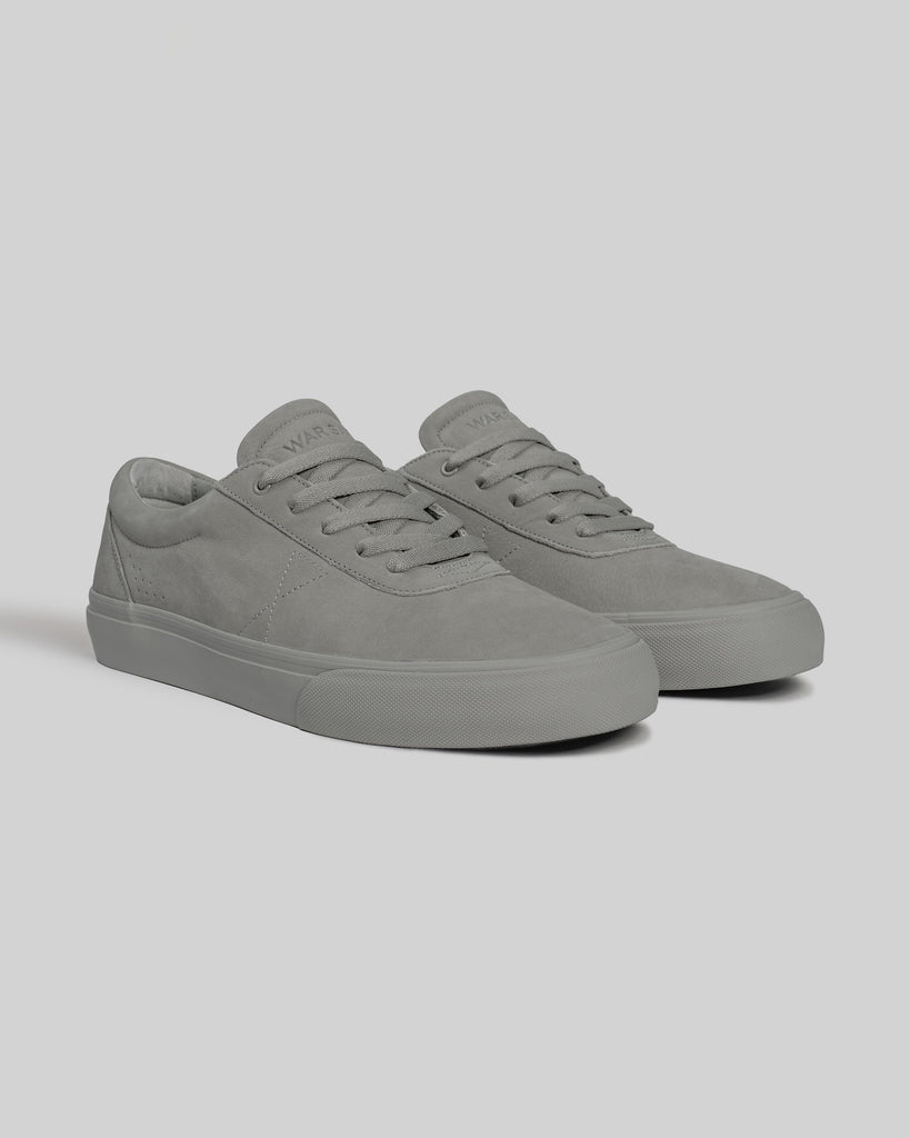 The CHAPTER | STONE FG NUBUCK sneakers by WARSAW LTD feature gray full-grain nubuck suede uppers, laces, and rubber soles for a minimalist look, showcased on a plain light background.