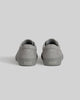 A pair of CHAPTER | STONE FG NUBUCK gray sneakers by WARSAW LTD, crafted in suede, are shown from the back on a light gray background with "WARSAW" displayed on the heels, exemplifying minimalistic design.