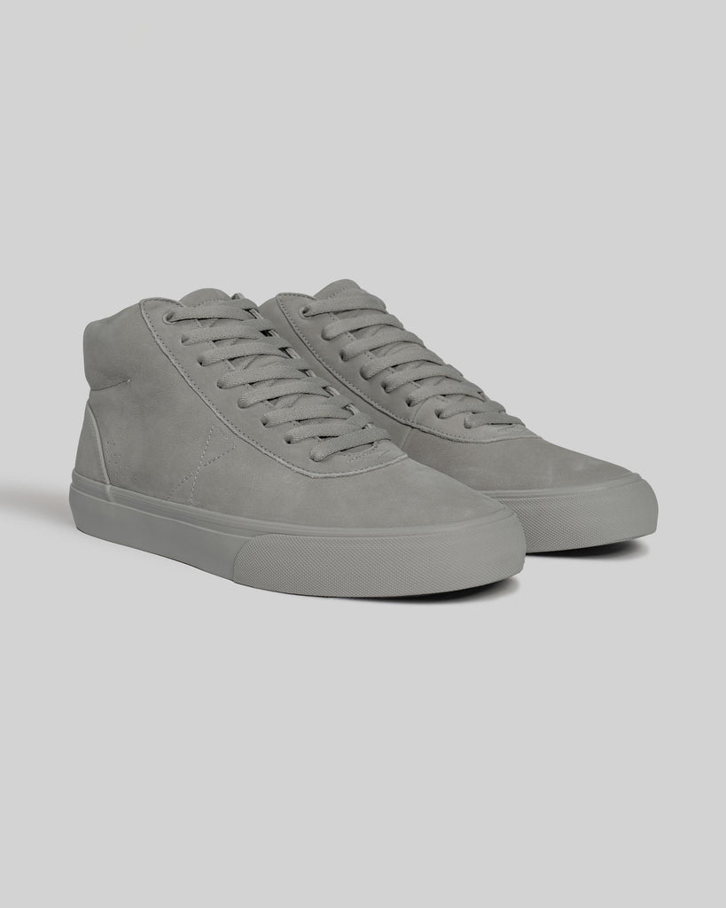 The CHAPTER MID | STONE FG NUBUCK by WARSAW LTD are gray high-top sneakers crafted from full-grain nubuck—ideal for fans of skate-inspired footwear. Shown on a plain light background.