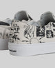 Close-up of the back of two white STRANGER SLIP-ON | TEMPLETON COLLAGE sneakers by WARSAW LTD, featuring black abstract graphics inspired by Ed’s paintings and "WAR SAW" on the heel tab. A true limited edition for skate enthusiasts.