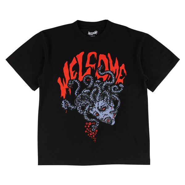 The WELCOME MEDUSA BOXY GARMENT-DYED TEE in black features Medusa's head graphic and bold red "WELCOME" lettering. Front and back designs from WELCOME add extra flair to this standout tee.