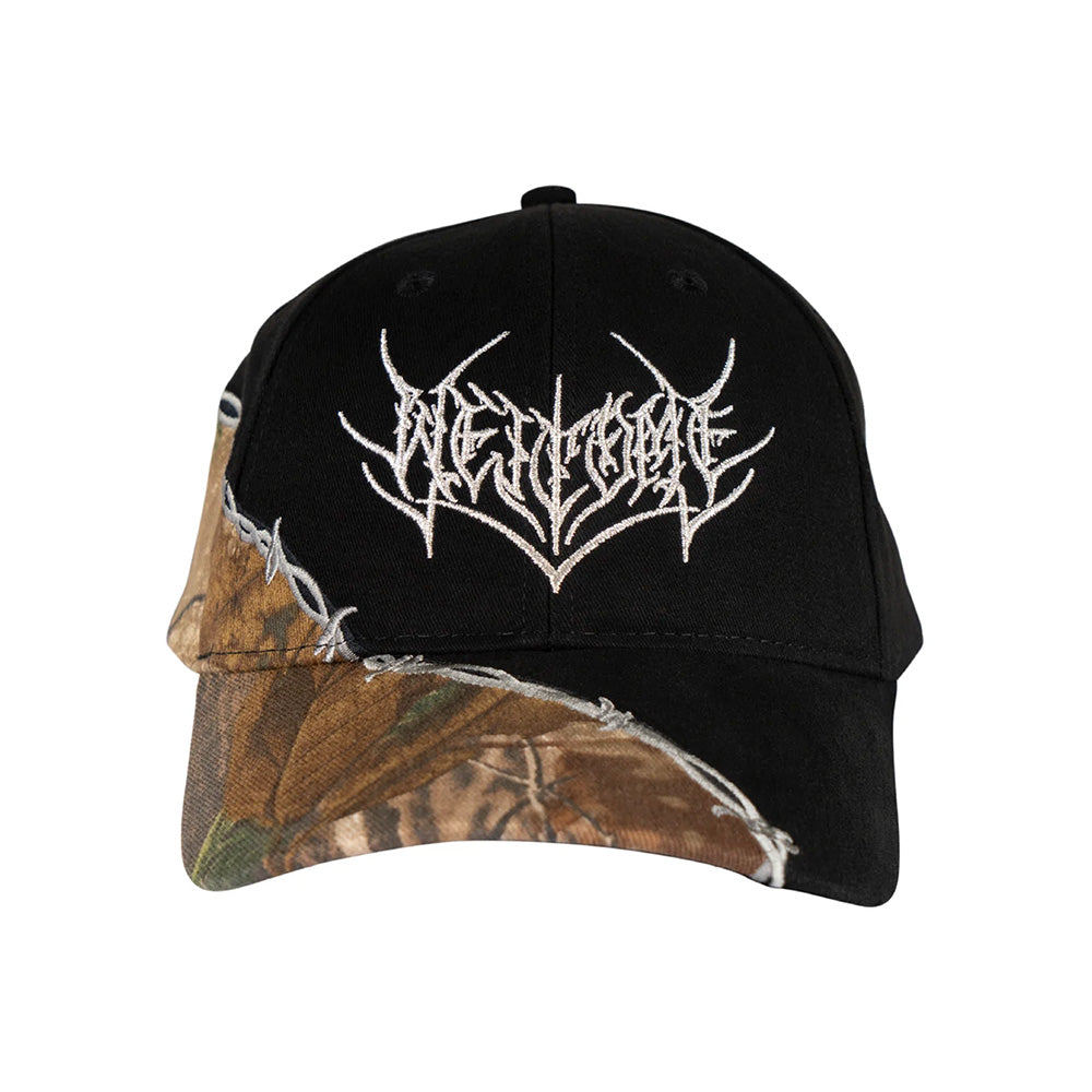 The WELCOME SPLINTER HAT BLACK by WELCOME is a black and camouflage trucker hat with a jagged white logo embroidered on the front and breathable mesh panels for comfort.