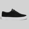 The CHAPTER | BLACK / WHITE SYNTHETIC by WARSAW LTD is a black low-top sneaker featuring synthetic material, black laces, and a white rubber sole, displayed in side profile against a plain gray background.