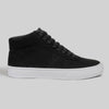 The CHAPTER MID | BLACK / WHITE SYNTHETIC by WARSAW LTD is a black high-top sneaker with black laces, a white rubber sole, and premium synthetic suede, shown on a plain gray background.