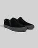 The WARSAW LTD STRANGER SLIP-ON | BLACK / BLACK features genuine pig suede uppers and rubber soles. These skate-inspired shoes are shown on a plain gray background.