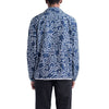 Model wears the HERSCHEL X KEITH HARING VOYAGE COACH jacket in blue with a white abstract line pattern by HERSCHEL, shown from the back and paired with black pants.