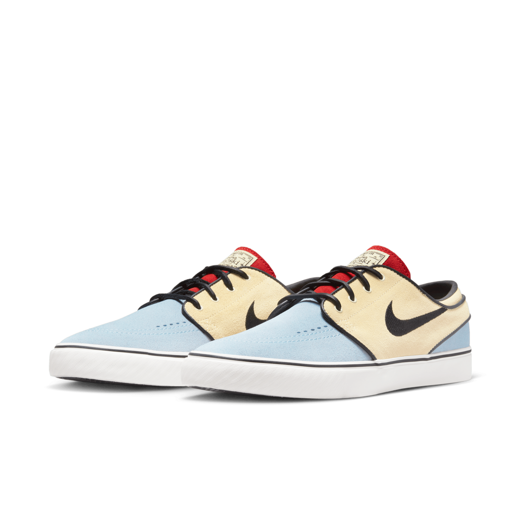 A pair of Nike SB Zoom Janoski OG+ Alabaster / Chile Red shoes with black and red accents.
