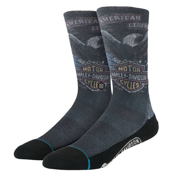 A pair of STANCE SOCKS HARLEY DAVIDSON black crew socks by STANCE, featuring the Harley-Davidson logo, "American Legend" text, and eagle graphics on the upper part.