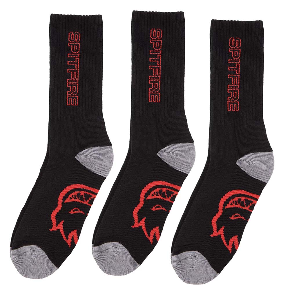 Three black and grey SPITFIRE CLASSIC 87 SOCKS with red "spitfire" text and a red flame logo design, packaged in a SPITFIRE CLASSIC 87 SOCKS 3 PACK BLACK/RED/GREY.