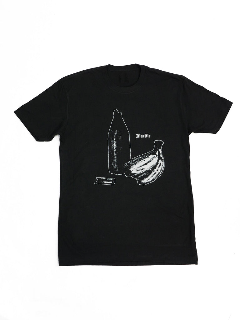 A BLUETILE SAVA STILL LIFE T-SHIRT BLACK featuring a drawing of a banana and a bottle by artist Sava Kucherin as part of the Bluetile Collab by Bluetile Skateboards.