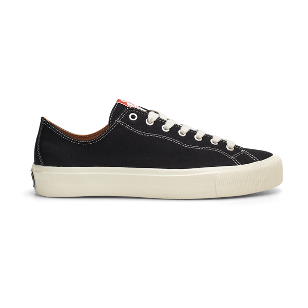 A pair of black sneakers with white soles, made with LAST RESORT AB VM003 CANVAS BLACK/WHITE material.