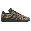 A camouflage print adidas Busenitz Black/Cardboard/Gold sneakers on a white background.