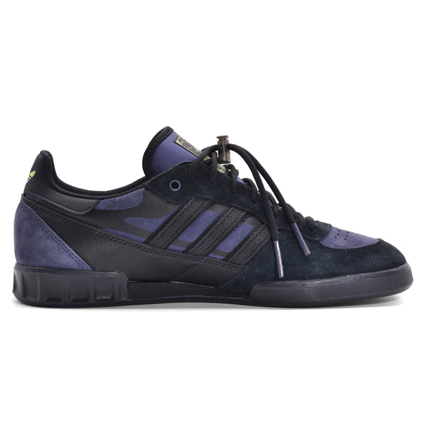 A pair of ADIDAS HANDBALL TOP X MIKE ARNOLD BLACK/DARK BLUE sneakers.