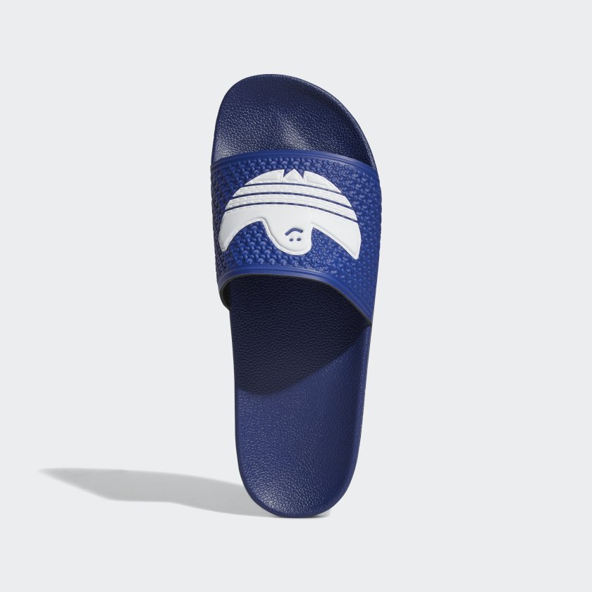 A blue ADIDAS SHMOOFOIL SLIDE VICTORY BLUE / WHITE slipper.