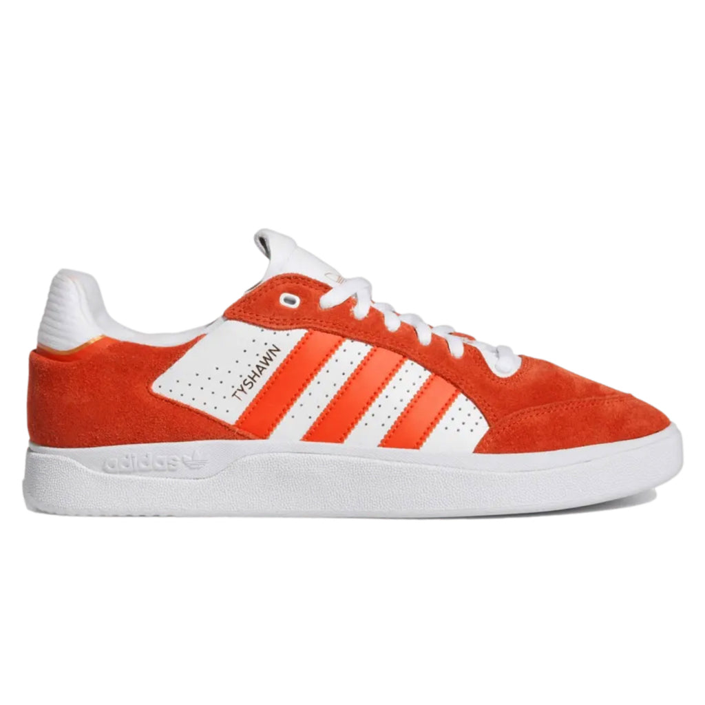 A red and white ADIDAS Tyshawn Low Collegiate Orange / Collegiate Orang / White sneakers.