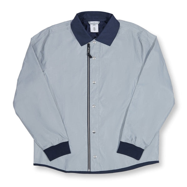 An ADIDAS X BLONDEY JOUSTING JACKET SILVER METALLIC with a navy collar and cuffs.