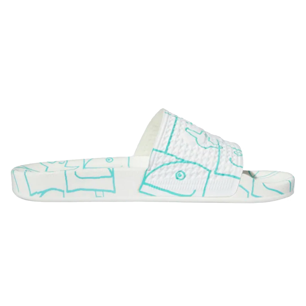 An Adidas SHMOOFOIL SLIDE CLOUD WHITE / SEMI MINT - a slide on sandal by Adidas with a design on it.