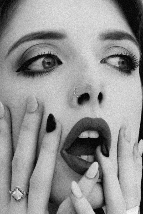 A black and white Type O by Savannah Bockus photo print of Savannah Bockus with her hands on her face.