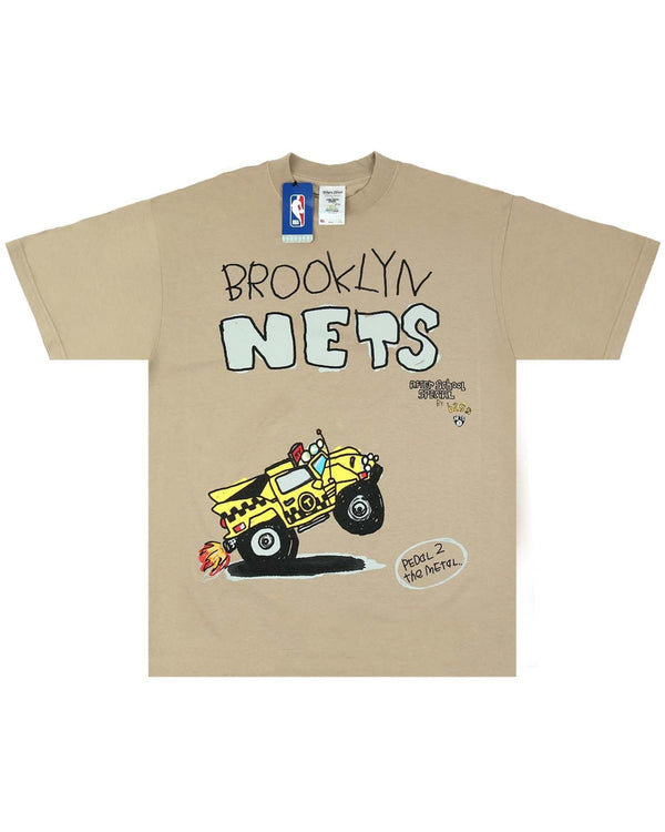 The AFTER SCHOOL SPECIAL X SHAKA WEAR X NBA NETS TEE OATMEAL is a premium heavyweight tan t-shirt featuring "Brooklyn Nets" text and an illustration of a yellow monster truck, complete with an NBA logo tag on the collar.