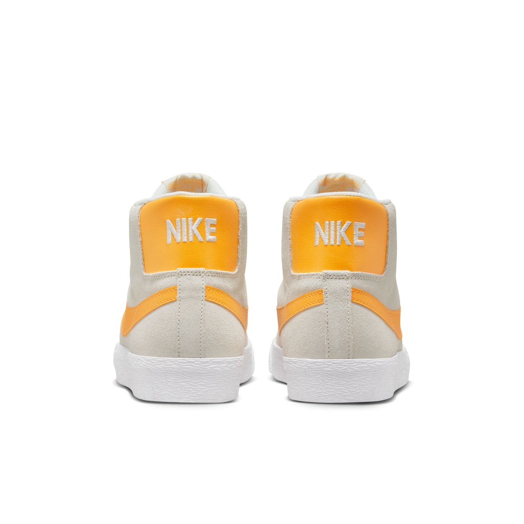 A pair of Nike SB Blazer Mid Summit White/Laser Orange sneakers.