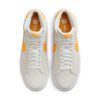 A pair of Nike SB Blazer Mid Summit White / Laser Orange sneakers on a white background.