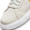 A close up of a white Nike SB Blazer Mid Summit White/Laser Orange tennis shoe.