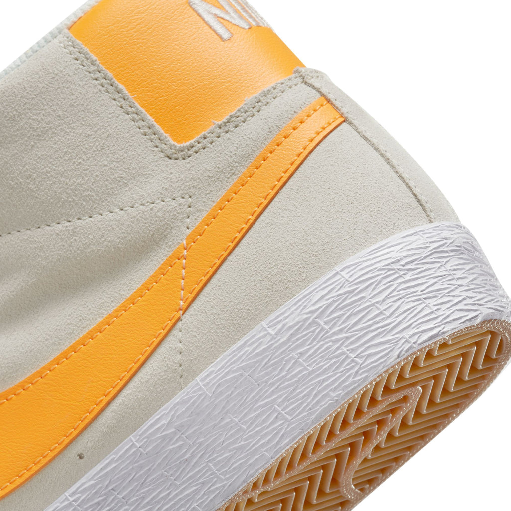 A close up of a Nike SB Blazer Mid Summit White / Laser Orange shoe.