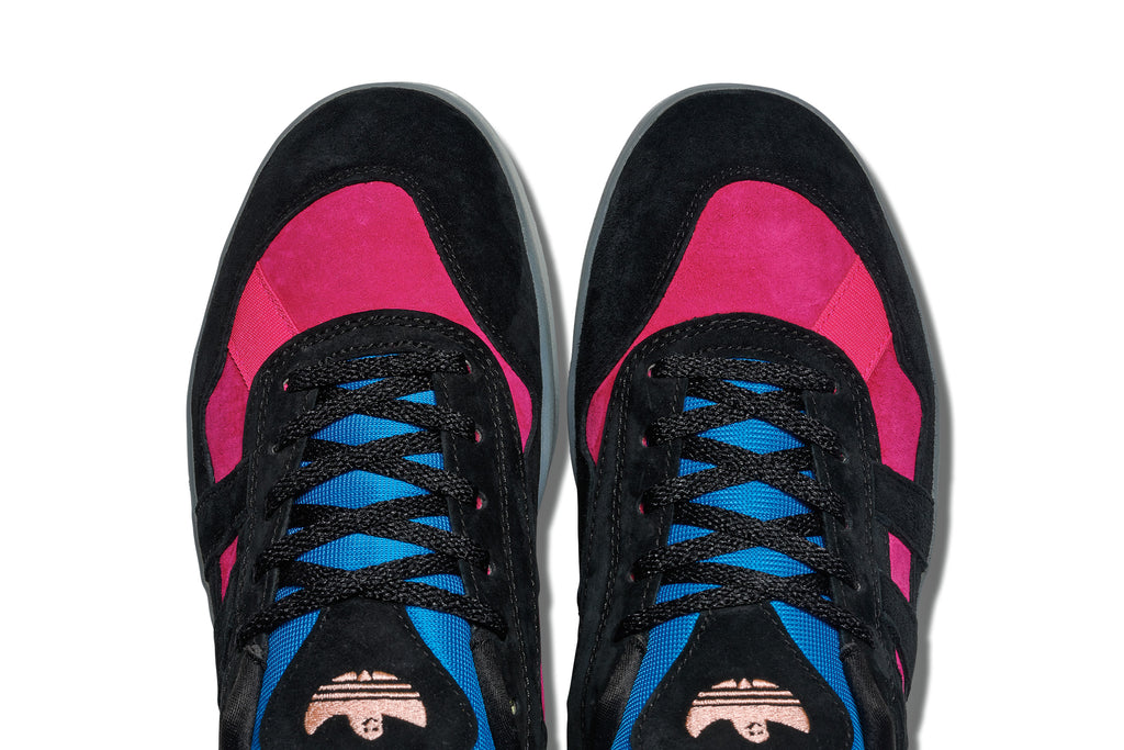 A pair of black and blue ADIDAS GONZ ALOHA SUPER "EIGHTIES" sneakers with pink accents.