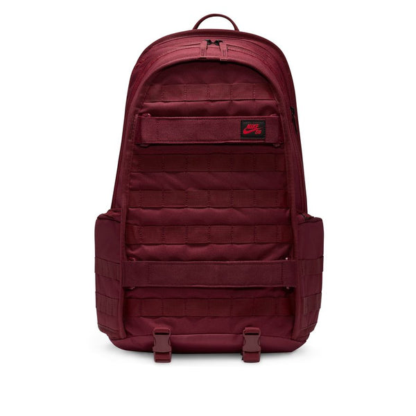 The NIKE SB RPM BACKPACK DARK BEETROOT by Nike features multiple compartments, a front zip pocket, side pockets, top handle, and adjustable straps. This water-resistant backpack keeps your gear secure and organized on the go.