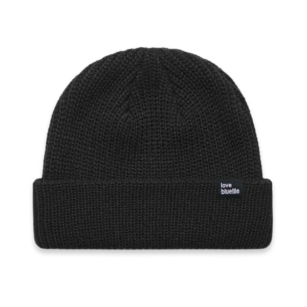 A Bluetile Skateboards black knit beanie on a white background.