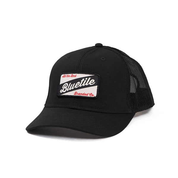 A BLUETILE CRAFT PATCH TRUCKER BLACK hat with a craft patch on it, made by Bluetile Skateboards.