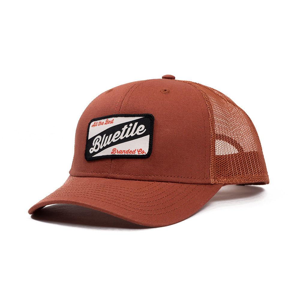A BLUETILE CRAFT PATCH TRUCKER CLAY hat with a patch on it. (Brand: Bluetile Skateboards)