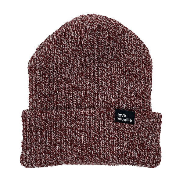 A burgundy marble knitted beanie with a black BLUETILE label.