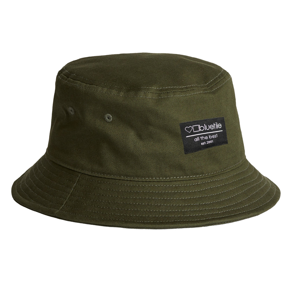 An Bluetile Skateboards army green bucket hat made of cotton, with a Bluetile Supply Co. logo on it.