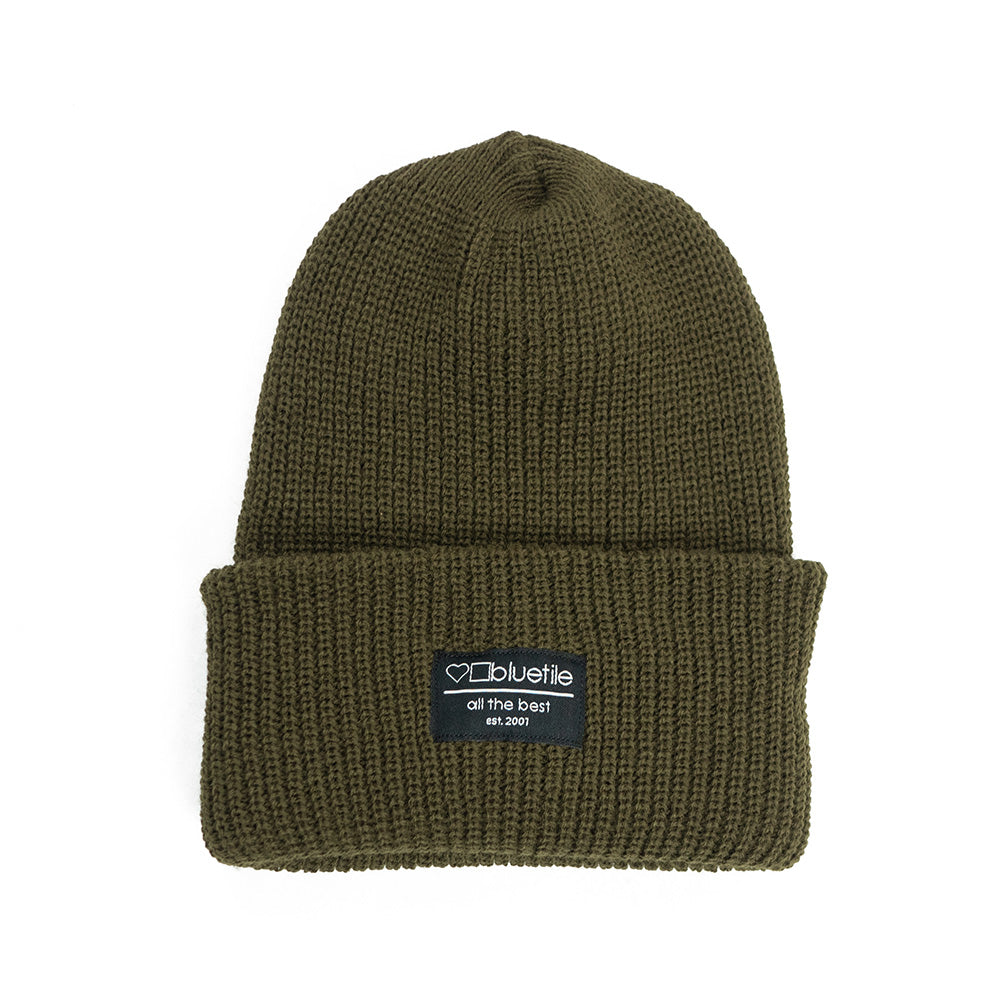 A BLUETILE SURPLUS BEANIE OLIVE DRAB with a label on it.