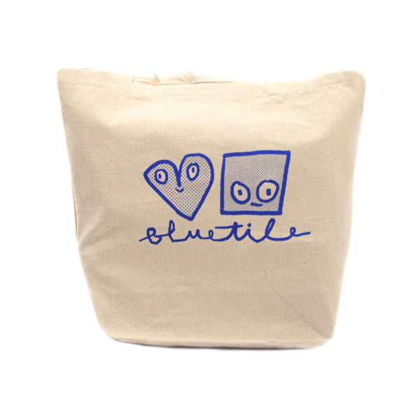 A BLUETILE X SPINA CURSIVE LOGO TOTE bag with the word love written on it.