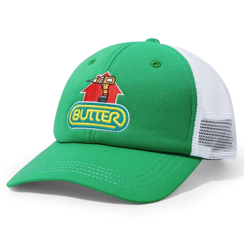 A green Trucker Cap with a drill and the word butter on it.