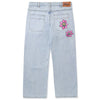 A pair of Butter Goods Flower Denim Jeans Light Blue with pink flowers on the side.
