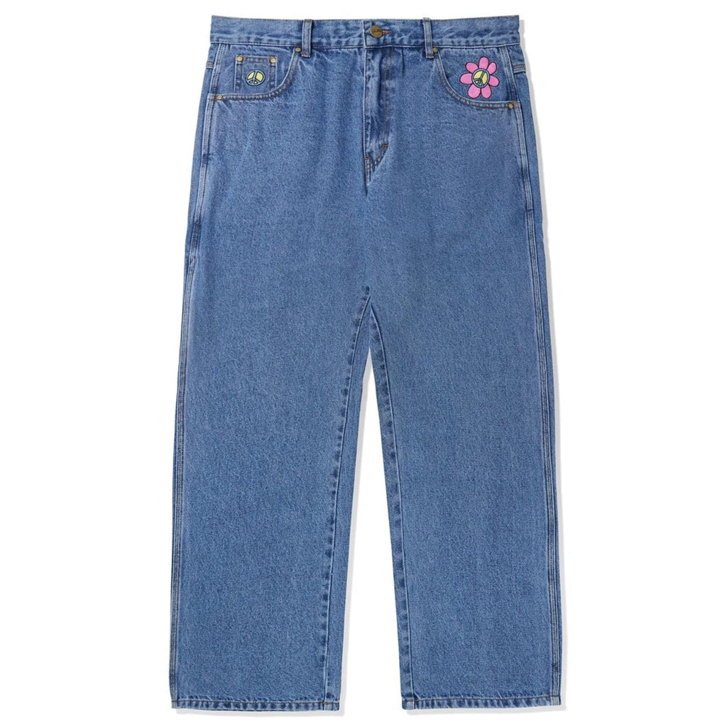 A pair of BUTTER GOODS FLOWER DENIM JEANS WASHED INDIGO from Butter Goods with a flower on the side.
