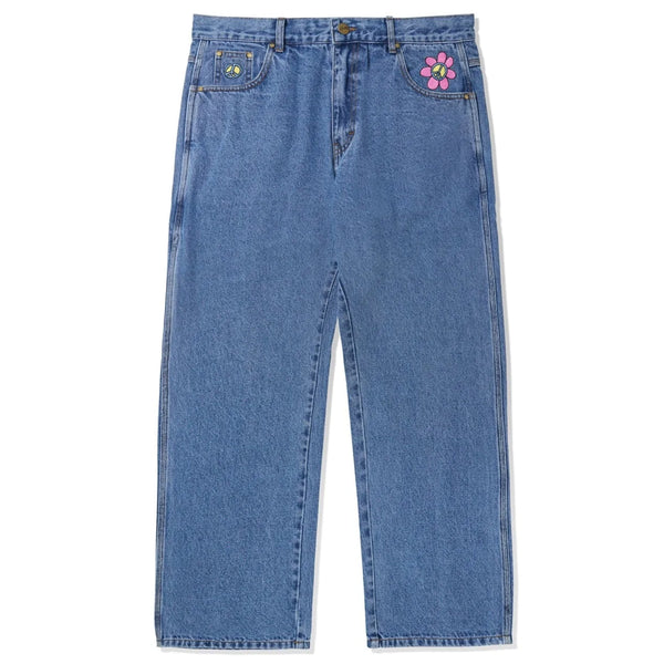 A pair of BUTTER GOODS FLOWER DENIM JEANS WASHED INDIGO from Butter Goods with a flower on the side.