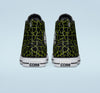 A back view of shoes that are black and green giraffe print.
