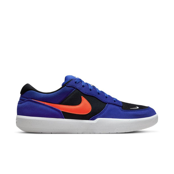 The NIKE SB FORCE 58 Concord/Team Orange-Black-Concord sneaker, featuring a blue and black design with an orange Swoosh and white sole, is now available at Bluetile Skateboards in Columbia, SC.