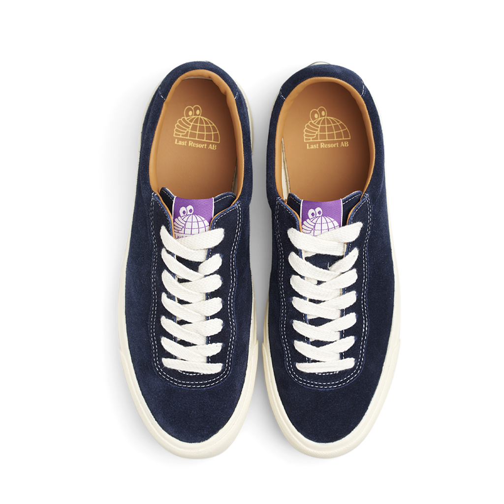 A pair of navy sued sneakers with purple laces, suitable for a LAST RESORT AB VM001 OLD BLUE/WHITE or a touch of Last Resort AB.