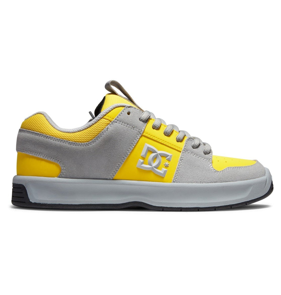 A yellow and grey DC LYNX ZERO GREY / YELLOW shoes with a yellow and grey logo featuring the DC brand.