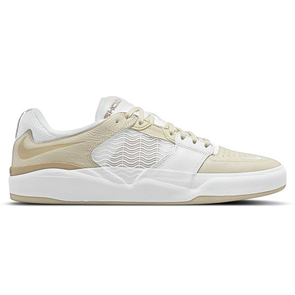 A white and cream colored nike shoe with a wavey design on the side