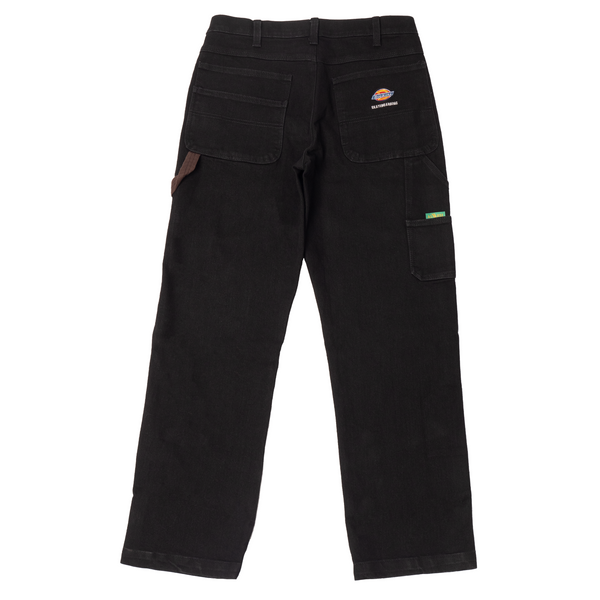 A pair of DICKIES VINCENT ALVAREZ DENIM PANT BLACK with a patch on the side.
