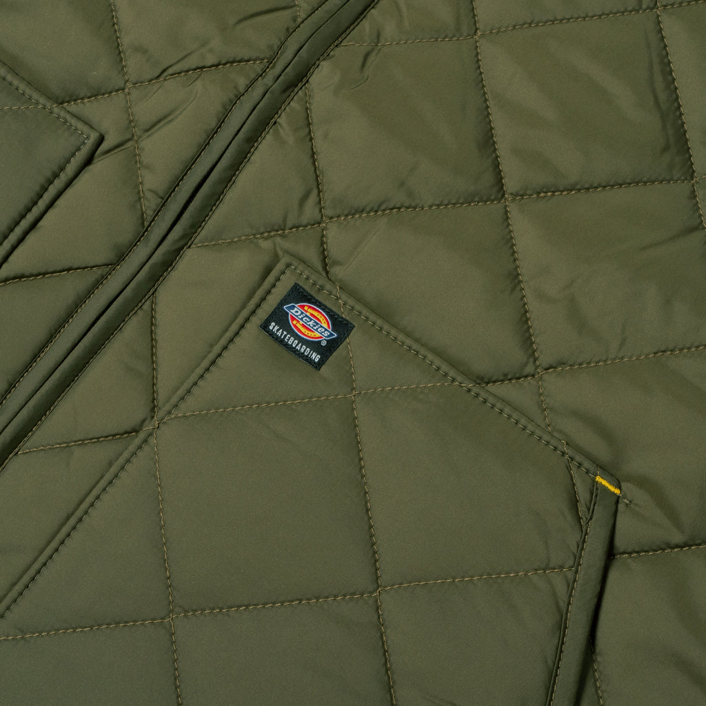 A close up of a Dickies jacket with a patch on it.